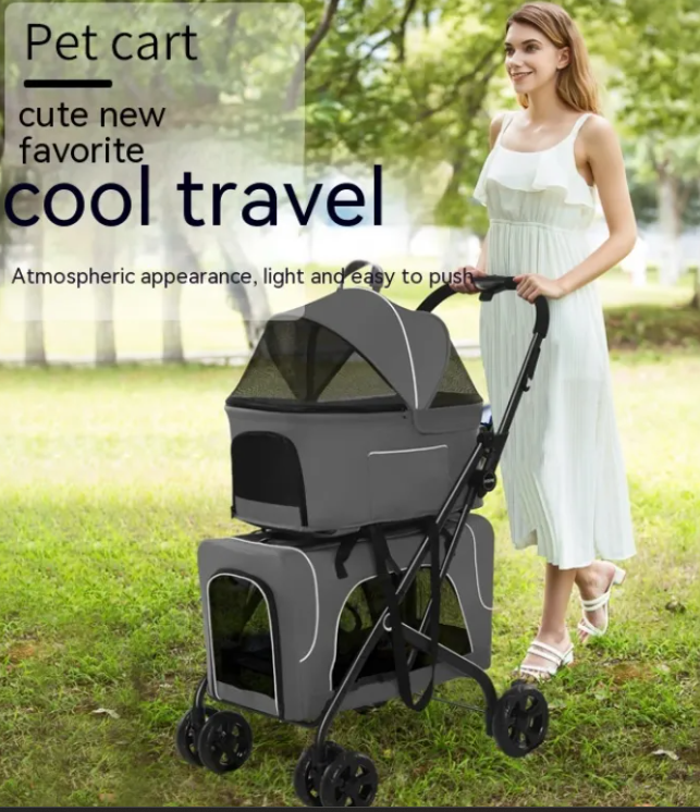 Small dog lightweight folding trolley with gray cloth, two-tier carriers and mesh canopy, being pushed in a park.